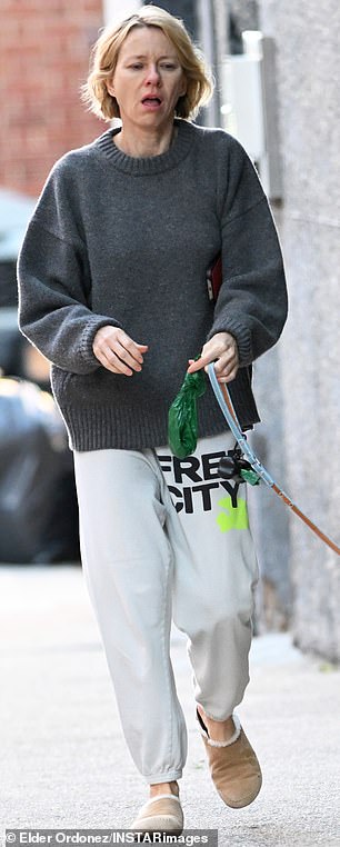 She pulled on a cozy-looking boyfriend fit dark grey sweater