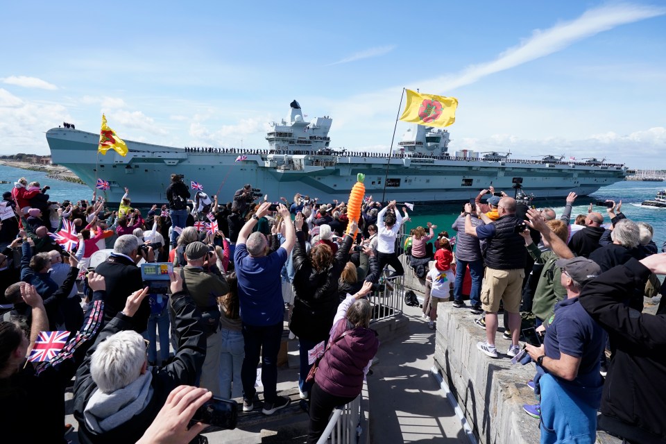 Crowds wave goodbye to the HMS Prince of Wales aircraft carrier as it departs Portsmouth.