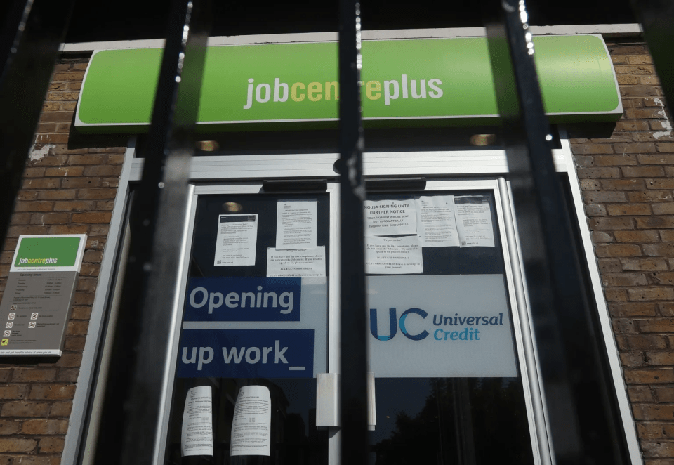 A Jobcentre Plus building with "Opening up work" and "Universal Credit" signs on the door.