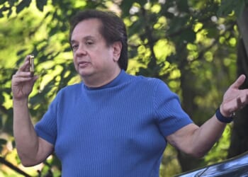 George T. Conway III, husband of former White House counselor Kellyanne Conway, speaks on the phone outside the home of John Bolton, Donald Trump's former national security advisor, after the FBI conducted a court-authorized search of the residence on Aug. 22, 2025, in Bethesda, Maryland.