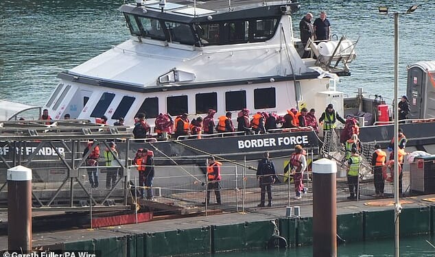 Migrants arrive at the Port of Dover yesterday - the same day a previously-deported migrant came back to Britain