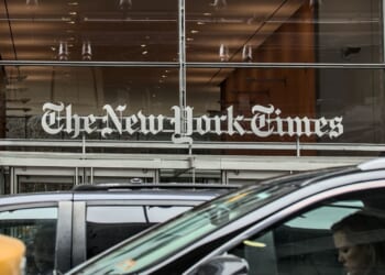 Cars and cabs drive outside of The New York Times corporate headquarters in Times Square, Manhattan, New York City.
