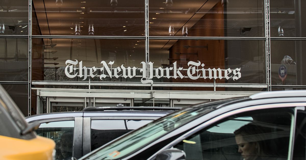 Cars and cabs drive outside of The New York Times corporate headquarters in Times Square, Manhattan, New York City.