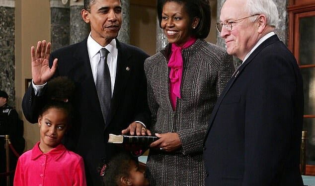 Barack Obama, his wife Michelle and their daughters Malia and Sasha as he is sworn in as a US Senator by vice president Dick Cheney on January 4, 2005, in Washington, DC