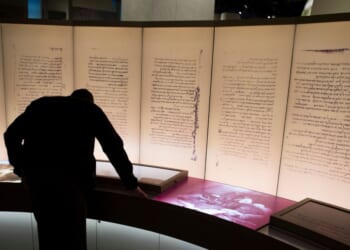 A visitor looks at an exhibit on the Dead Sea Scrolls at the Museum of the Bible in Washington, DC on Nov. 14, 2017.