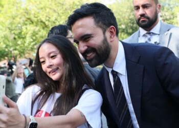 New York mayoral candidate Zohran Mamdani takes a selfie with a young woman after speaking at a press conference on Sept. 26, 2025, in New York City.