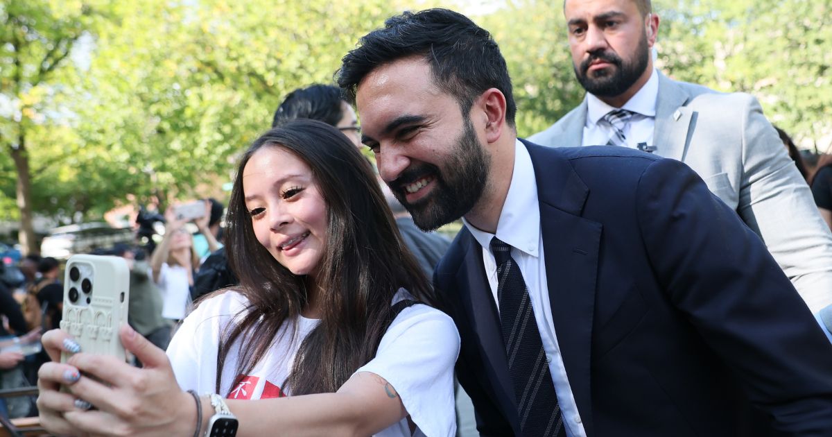 New York mayoral candidate Zohran Mamdani takes a selfie with a young woman after speaking at a press conference on Sept. 26, 2025, in New York City.