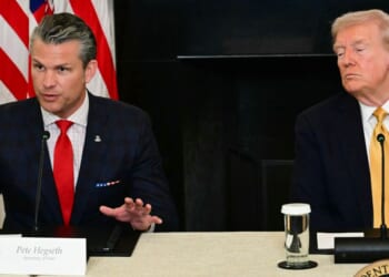 President Donald Trump listens to Defense Secretary Pete Hegseth during a law enforcement roundtable in the State Dining Room of the White House on Oct. 23, 2025, in Washington, D.C.