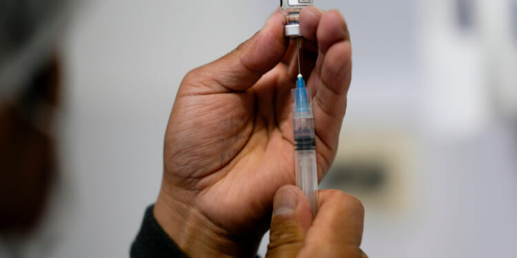 A health care worker prepares a shot of the Pfizer COVID-19 vaccine in La Paz, Bolivia, in a file photo taken Jan. 7.