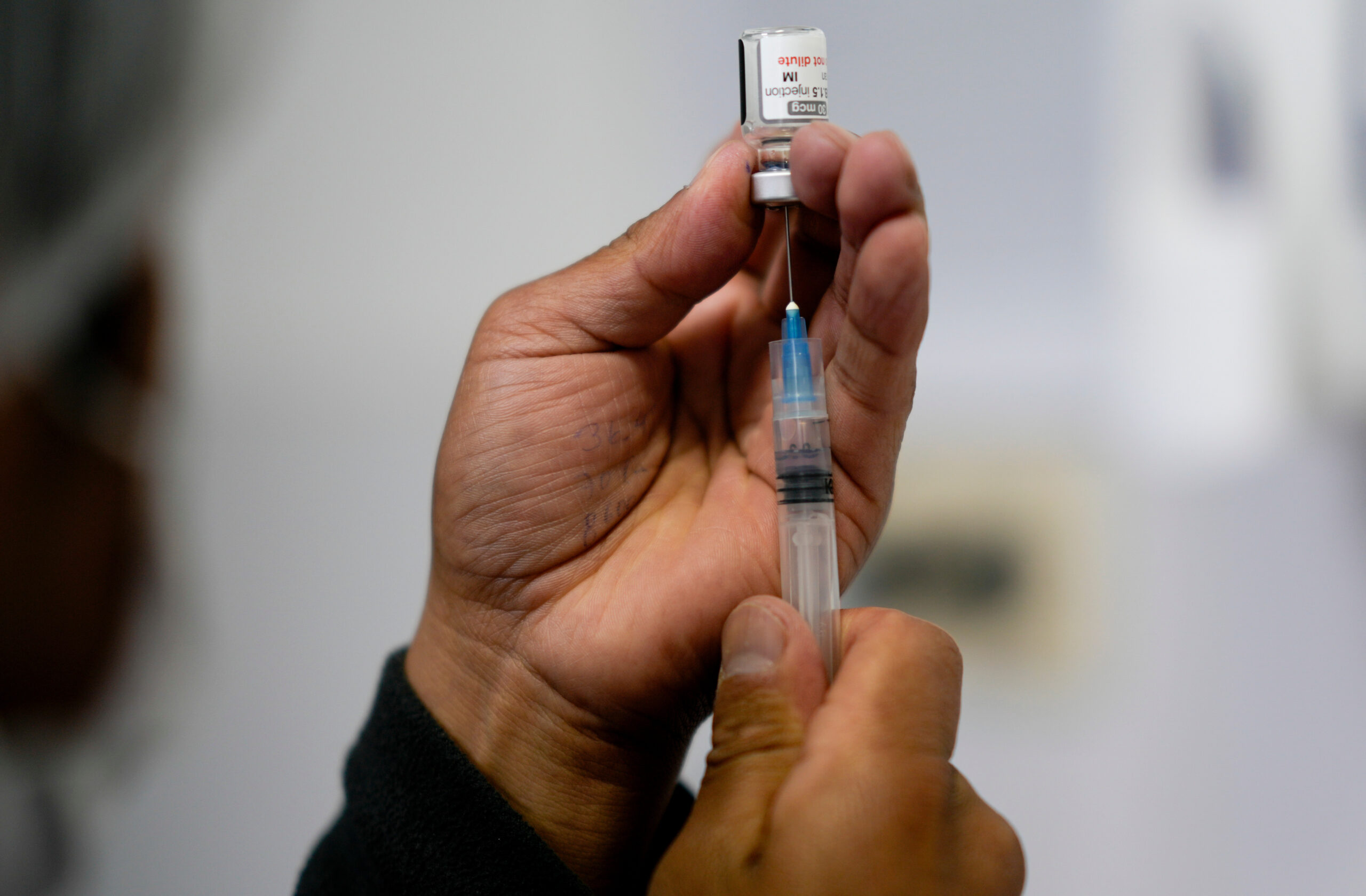 A health care worker prepares a shot of the Pfizer COVID-19 vaccine in La Paz, Bolivia, in a file photo taken Jan. 7.