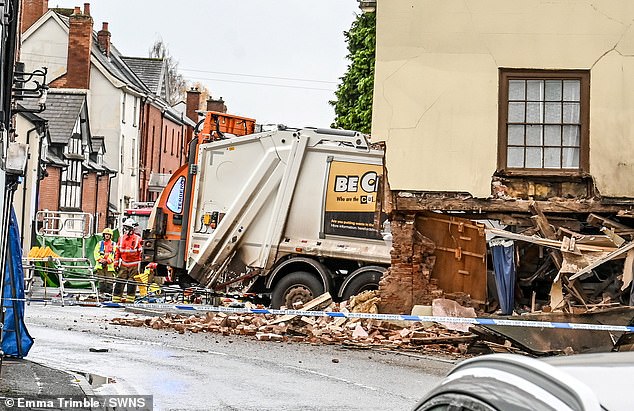 The scene where a bin lorry crashed into a house in Leominster, Herefordshire on Monday morning