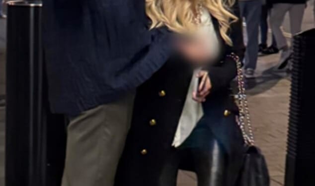 Police released this photo of two people they want to talk to after a family was allegedly racially abused and assaulted in central London (image blurred at source by British Transport Police)