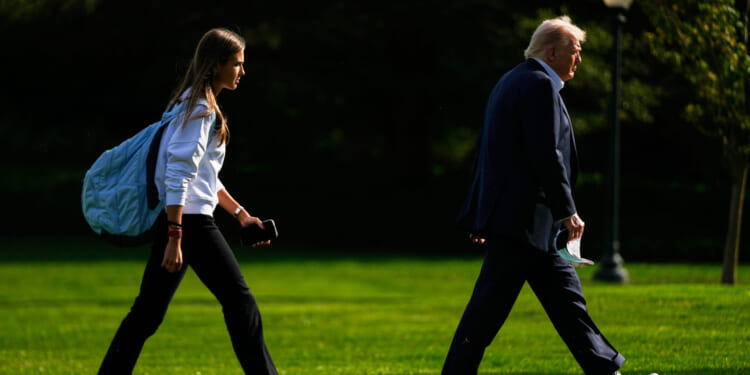 President Donald Trump, right, arrives with his granddaughter Kai Trump at the White House, Sept. 26.