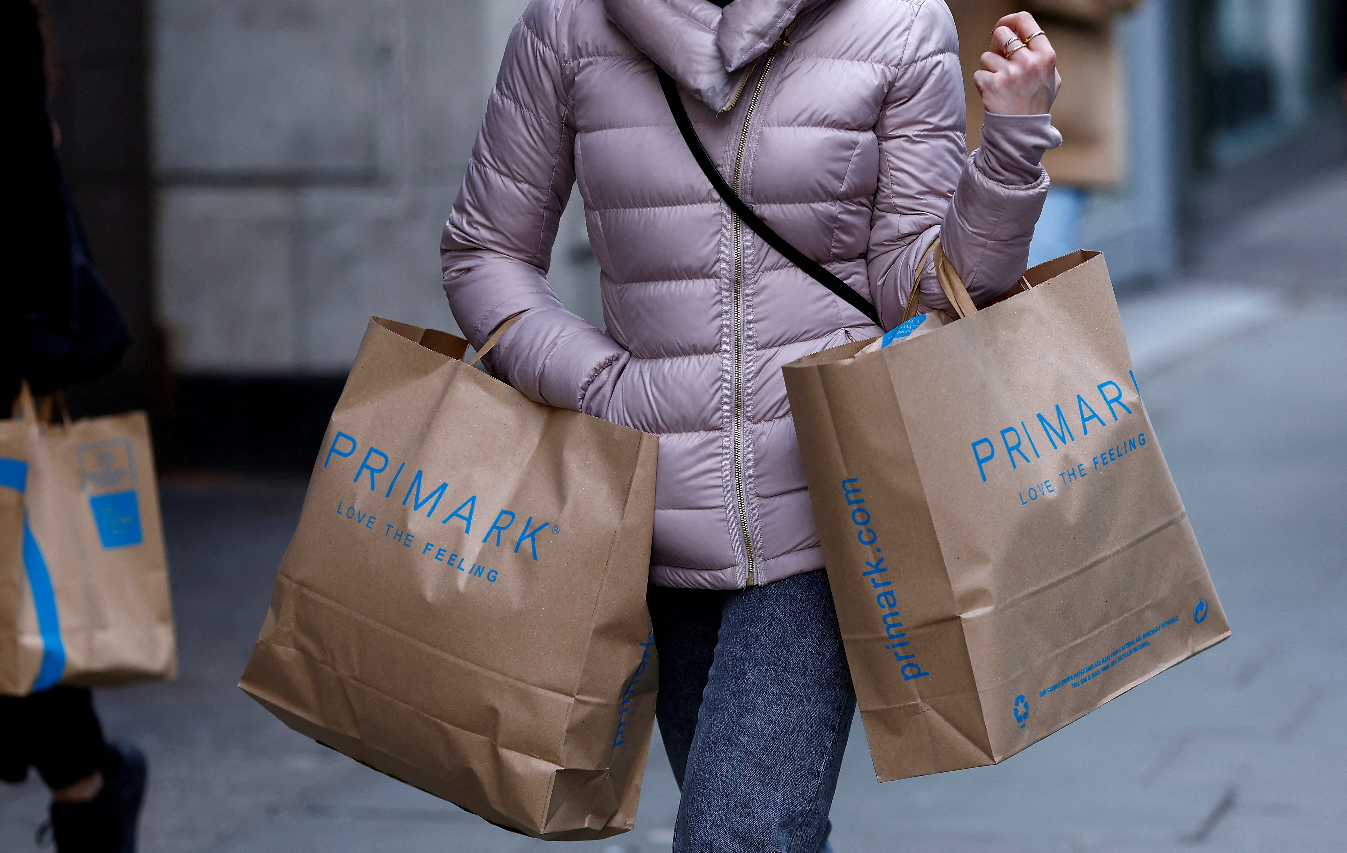 A woman carries Primark shopping bags on Oxford Street in London.