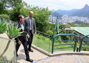 Mayor of Rio de Janeiro, Eduardo Paes speaks with Prince William, Prince of Wales on a visit to Sugarloaf Mountain during day one of his visit to Brazil