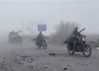 Haunting footage has emerged showing Russian troops advancing through thick fog in a convoy of wrecked cars, many missing doors and windows, in scenes likened to Mad Max