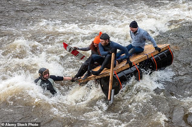 Audience members at the Boxing Day race in Matlock, Derbyshire, have been known to throw eggs and bags of flour during previous races with participants often returning fire with water pistols (Pictured: The Matlock Boxing Day Raft Race 2016)