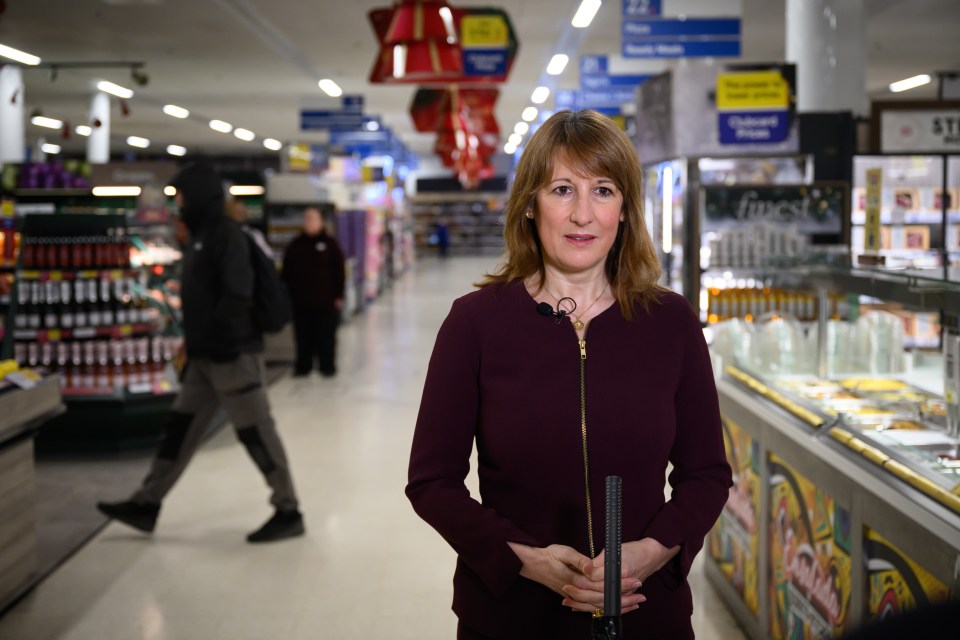 British Chancellor of the Exchequer Rachel Reeves speaking to the media in a supermarket aisle.