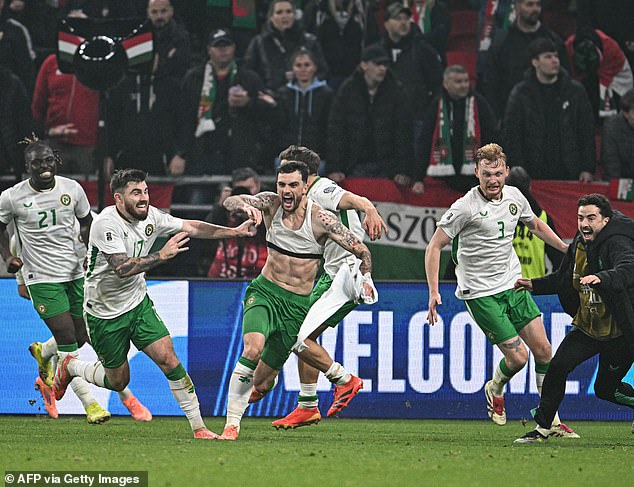 Troy Parrott hit a stunning hat-trick to help Ireland secure a World Cup play-off place in a dramatic qualifier at the Puskas Arena
