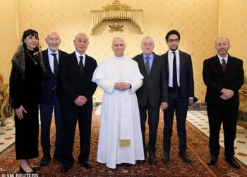 Pope Leo XIV poses for a photo with actor Robert De Niro and his daughter Drena at the Vatican on Friday