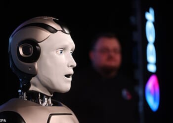 The bot, known as AIDOL, staggered out on stage triumphantly to the Rocky theme song in front of around 50 journalists before the machine shuffled to the left and waved to the audience