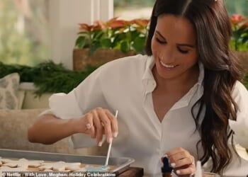 Pictured: Meghan smiling while painting snowflake cookies for Archie and Lilibet