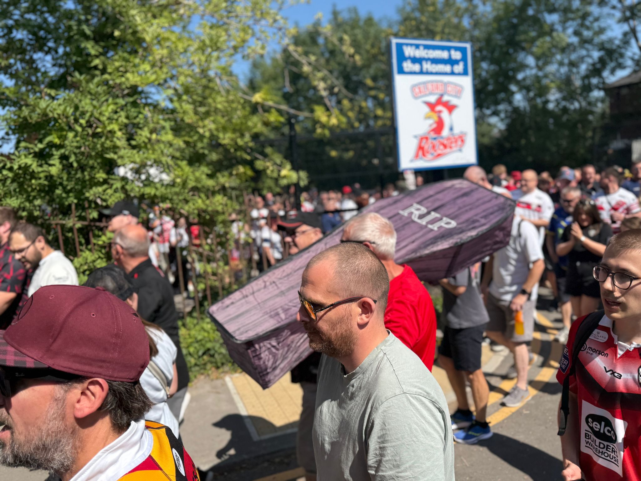 Salford rugby league fans protesting their owners, carrying a coffin.