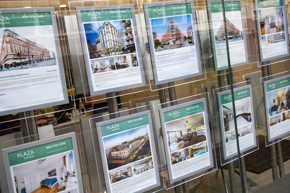Estate agent window display showcasing London properties for sale.