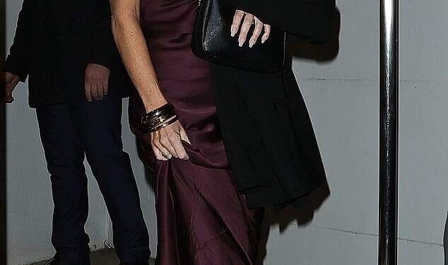 Joanne Beckham, 43, leaves Gordon Ramsay¿s restaurant in Chelsea, west London, wearing a burgundy silk dress designed by her sister-in-law Victoria after her brother David was knighted