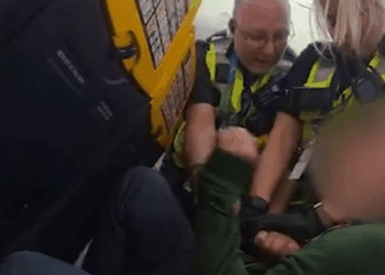 Shocking moment ‘drunk’ Brit passenger is grappled by cops on plane after ‘refusing to sit down during landing'