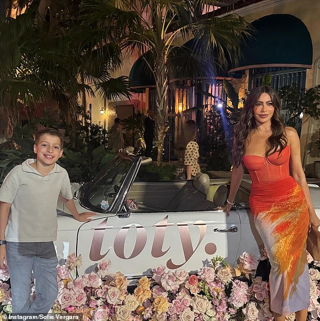 The Colombian bombshell posed next to a Toty car with a young boy