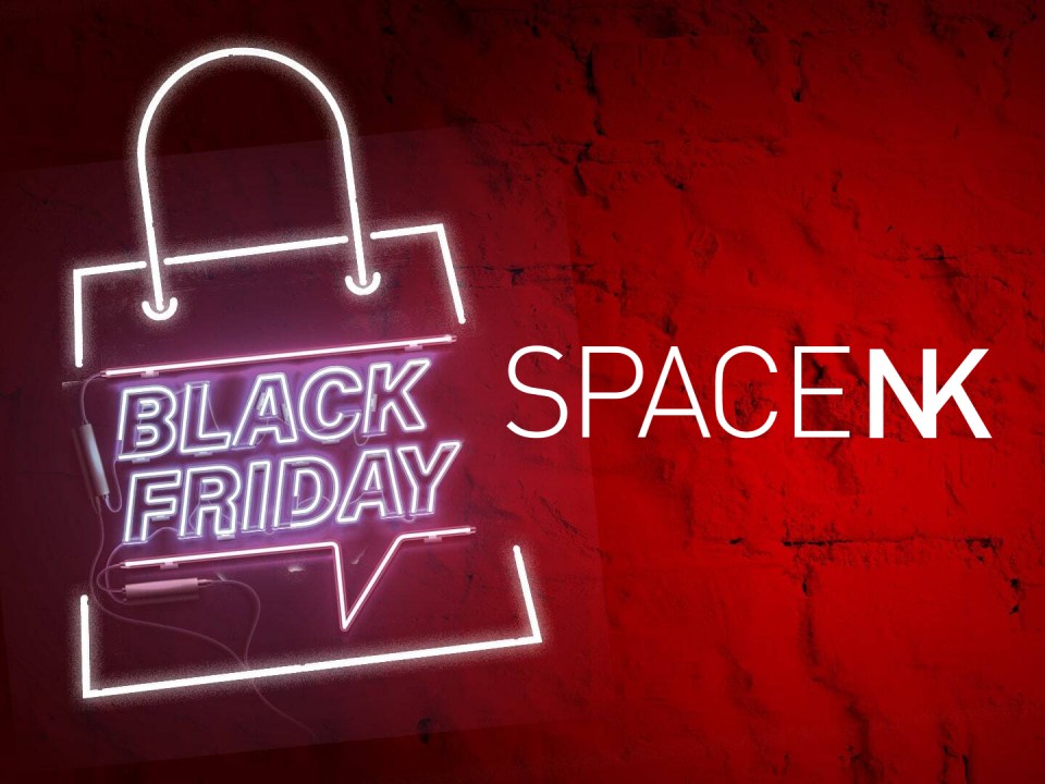 Illustration of a neon sign shaped like a shopping bag with "BLACK FRIDAY" inside, next to "SPACE NK" in white text, on a red background.