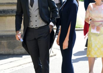 The Daily Mail can reveal that Victoria Beckham has made her husband the suit which he will wear as he is honoured for his services to sport and charity. Pictured: David Beckham and Victoria Beckham arrive at St George's Chapel at Windsor Castle before the wedding of Prince Harry to Meghan Markle on May 19, 2018