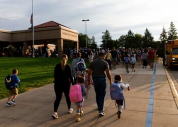 Parents drop off their children for the first day of school at Deerwood Elementary on Sept. 2, 2025, in Eagan, Minnesota.