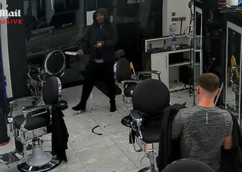 CCTV footage exclusively obtained by the Daily Mail allegedly shows a knifeman entering Ritzy Barbers in Peterborough, Cambridgeshire, on Friday