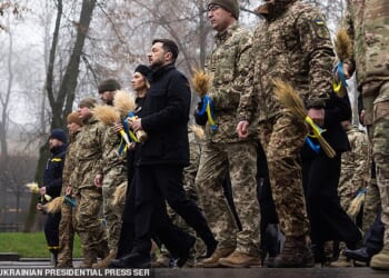 Ukraine's President Volodymyr Zelensky (pictured in black) with Ukrainian soldiers paying tribute to the victims of the famine of 1932-1933 at the National Museum of the Holodomor-Genocide in Kyiv