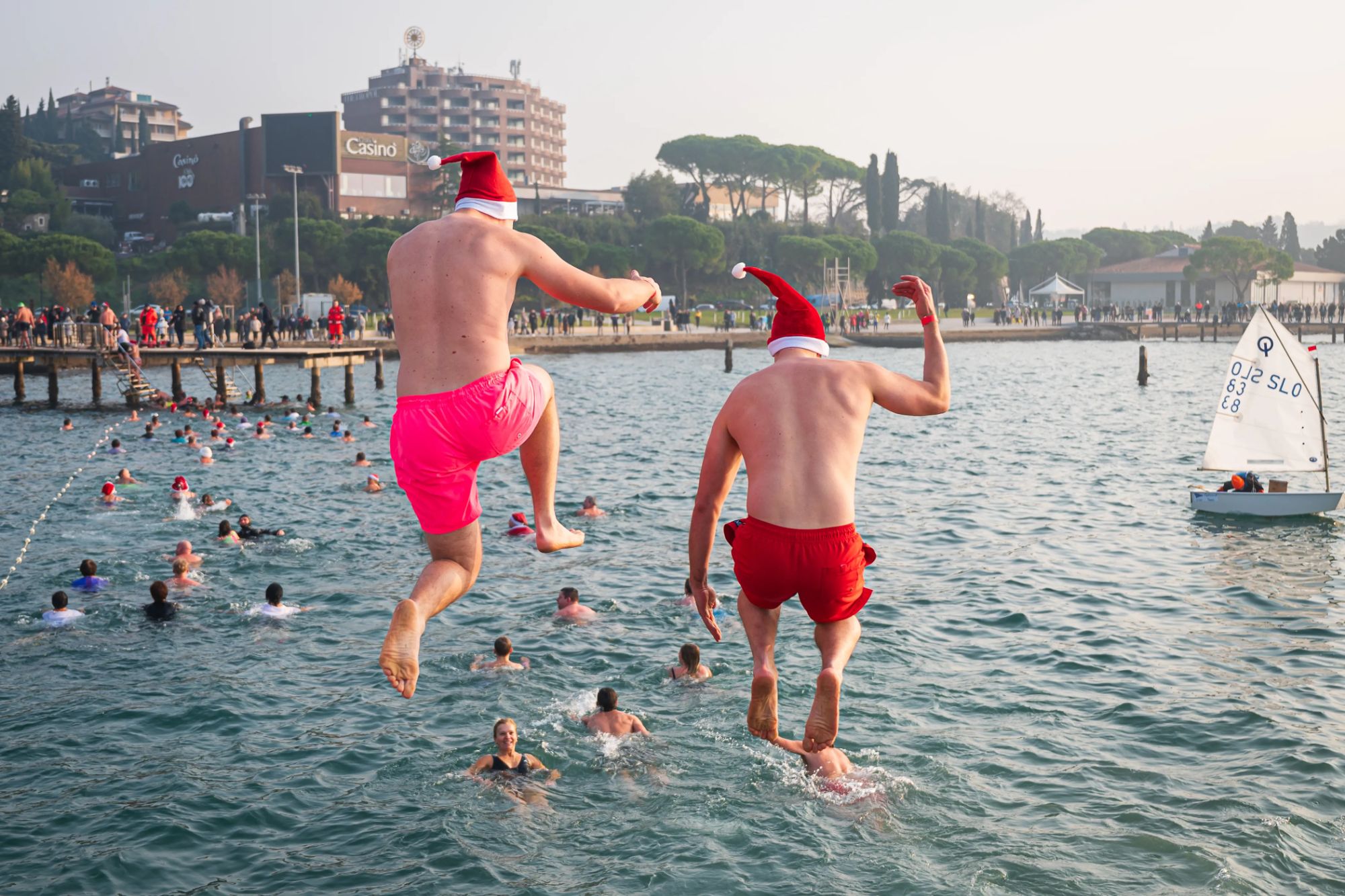 An image collage containing 1 images, Image 1 shows People plunge into the water as they attend the 19th edition