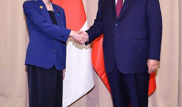 Japan's new prime minister Sanae Takiachi seen shaking hands with China's Xi Jinping - weeks after this photograph was taken, the two find themselves embroiled in a bitter war of words