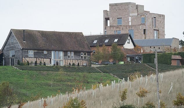 The 'brutalist' structure, (pictured) made of recycled bricks with a square-shaped tower, has been compared to a 'prison' and a 'multi-storey carpark'