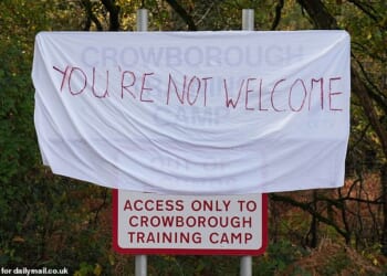 A 'you're not welcome' sign outside Crowborough Training Camp in East Sussex