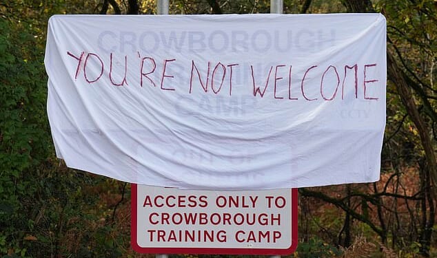 A 'you're not welcome' sign outside Crowborough Training Camp in East Sussex