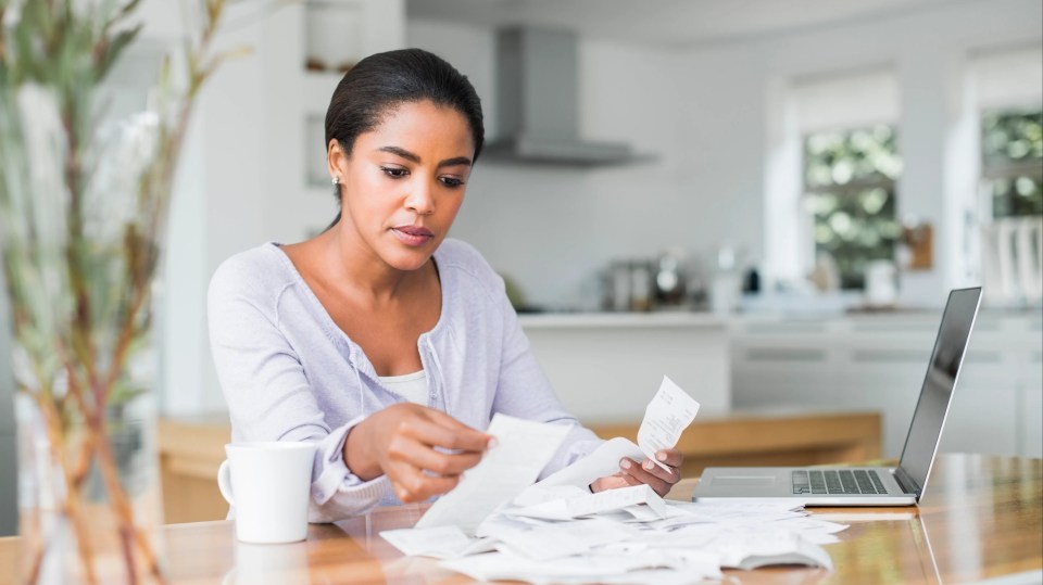Woman reviewing bills at home.
