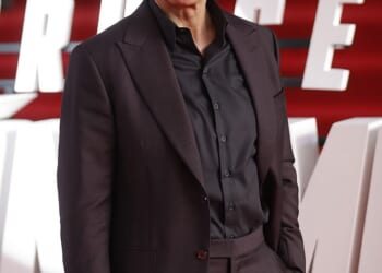 Tom Cruise 's fellow Scientologists blared bagpipe music at protesters as they looked to drown them out them as the Hollywood star jetted in to their UK headquarters