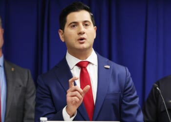 Acting U.S. Attorney Bill Essayli speaks as Los Angeles Police Department Chief Jim McDonnell and Special Agent in Charge Kenny Cooper of the Bureau of Alcohol, Tobacco, Firearms and Explosives, Los Angeles Field Division, look on at a press conference announcing an arrest in the Palisades Fire investigation on Oct. 8, 2025, in Los Angeles, California.