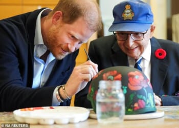 Harry painted poppies on an army helmet with 101-year-old veteran Jim LaForce who served in the Royal Canadian Air Force during World War Two