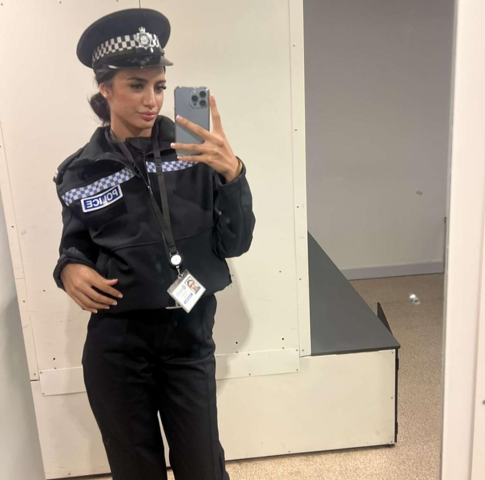 Maryam Ilyas in a police uniform, taking a mirror selfie with her phone.