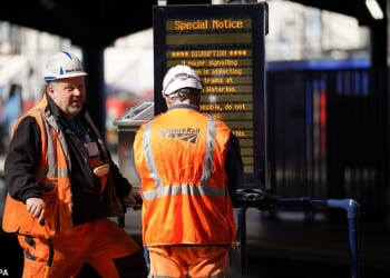 Brits racing home for Christmas face an unprecedented rail network shutdown - as a staggering 32 days of works are set to close main lines and hit 2,500 trains. (File image of Network Rail engineers in London Waterloo)