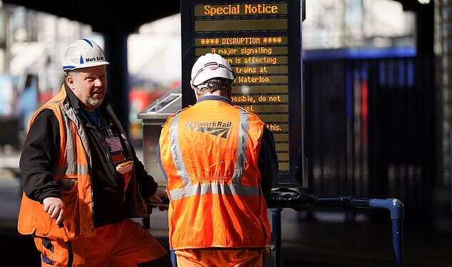 Brits racing home for Christmas face an unprecedented rail network shutdown - as a staggering 32 days of works are set to close main lines and hit 2,500 trains. (File image of Network Rail engineers in London Waterloo)