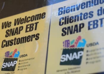 A sign welcoming customers who use SNAP sits outside of a convenience store in Baltimore on Nov. 10, 2025.
