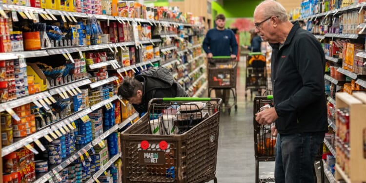 Shoppers look at a canned fish display Nov. 4, 2025, at the Market 32 Supermarket in South Burlington, Vermont.